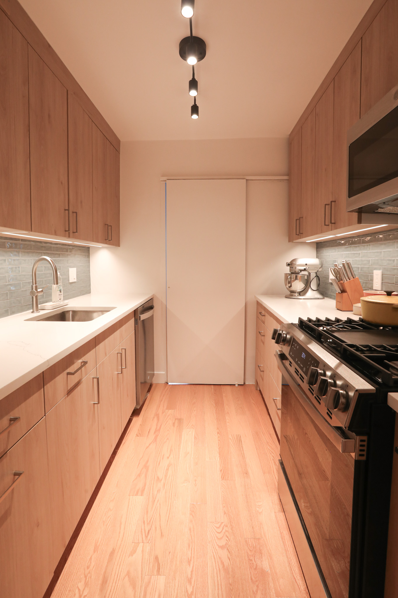 Kitchen — opposite angle with range and under-cabinet lighting